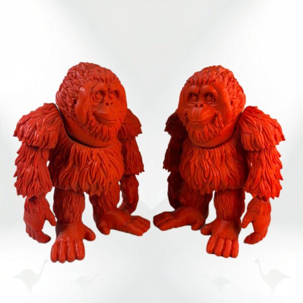 Two collectible Orangutan figurines, bright orange with detailed fur texture.