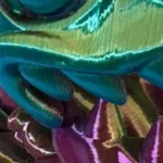 Iridescent fabric in teal, green, and purple hues.