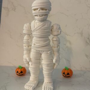 Boo Buddy Mummi 3D printed Halloween decoration. Spooky mummy figure with pumpkin accents, perfect for holiday decor.