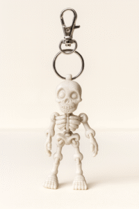Skeleton keychain with silver clip. Fun spooky accessory.