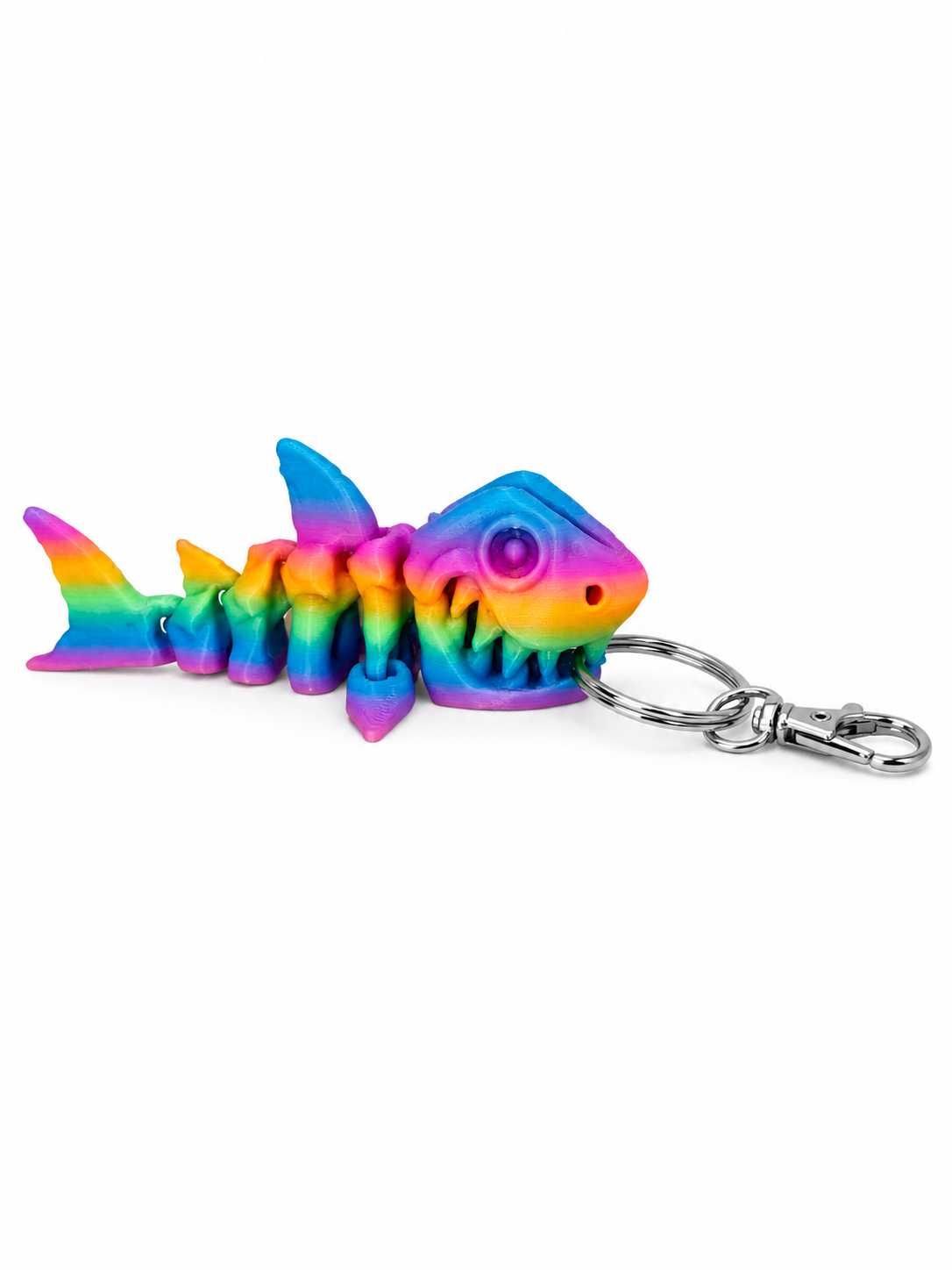 Rainbow-colored 3D printed articulated shark skeleton keychain with metal clasp.