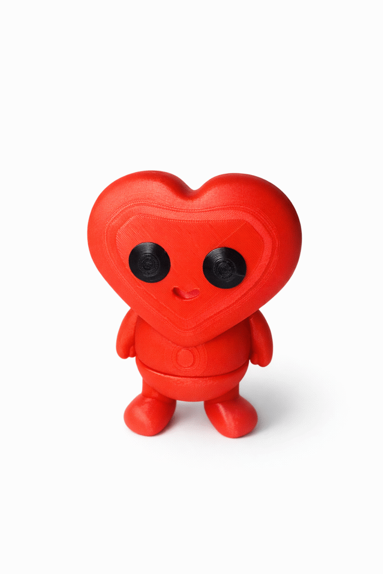 Axolotl (Copy): Red 3D printed heart-shaped robot figurine with black eyes and a small smile.