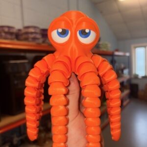 Orange Octopus toy with big blue eyes and segmented, flexible tentacles.