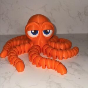 Orange Octopus toy with articulated tentacles and expressive blue eyes