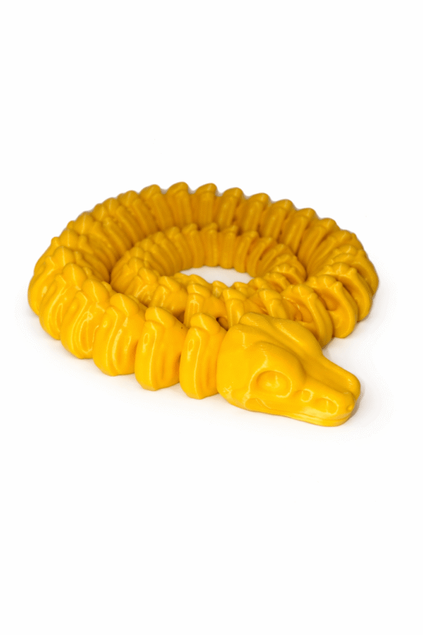 Yellow Skeleton Snake toy coiled. Articulated snake with skull head.