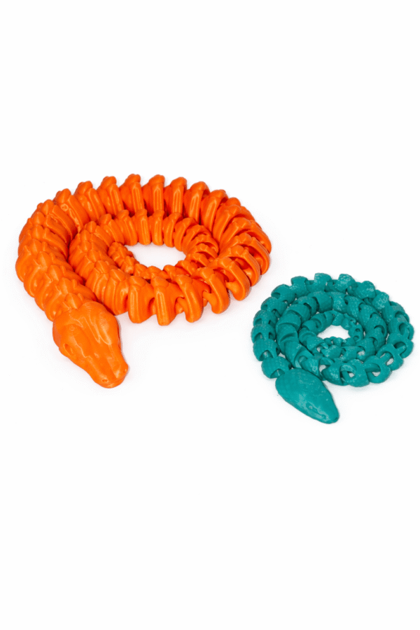 Orange and teal 3D printed Skeleton Snake toys coiled on a white background.
