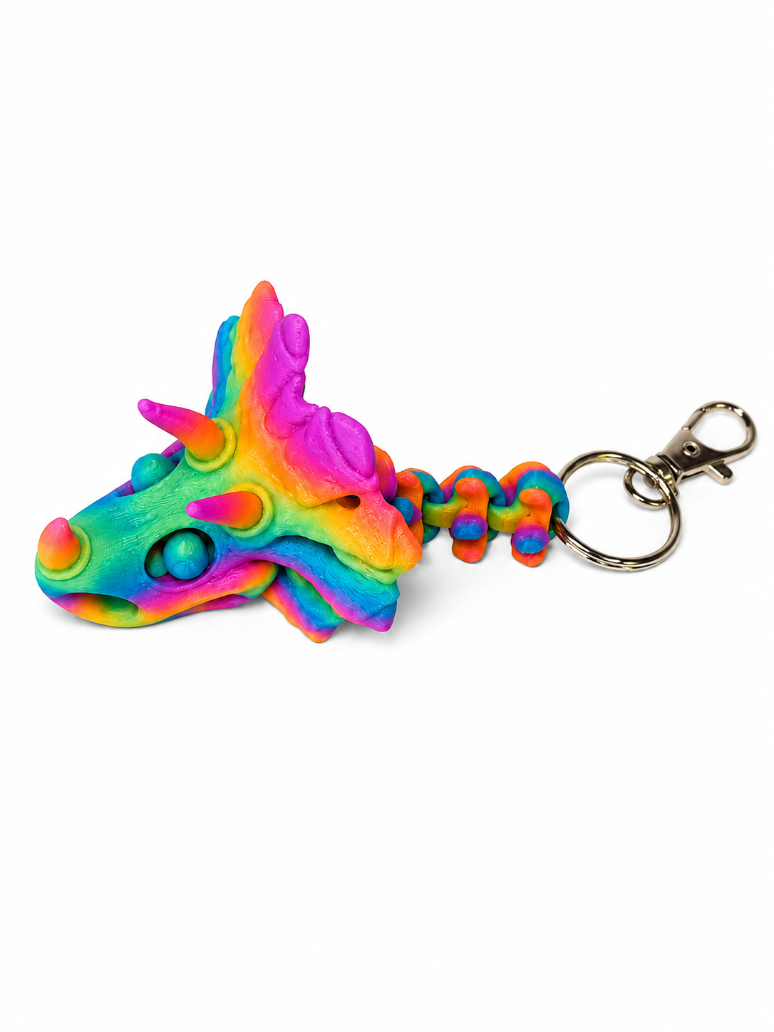 ChatGPT Image Jul 16 2026 11_21_20 AM Rainbow-colored triceratops skull keychain with a braided chain and silver clasp.
