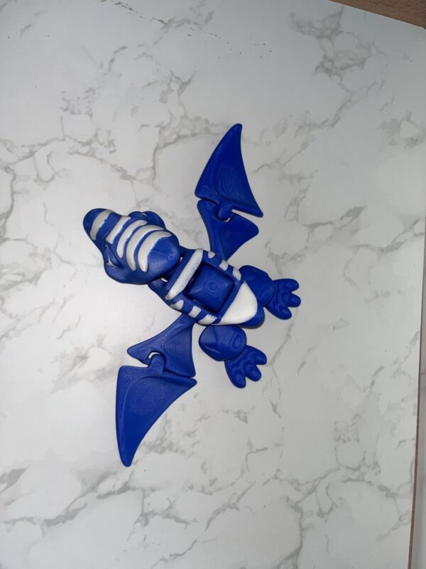 AUTO-DRAFT: Blue and white 3D-printed articulated pterodactyl toy, showcasing flexible design.