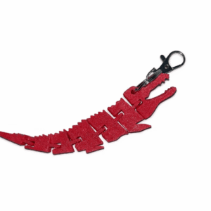 Red crocodile keyring. Flexible, articulated design with metal clip.
