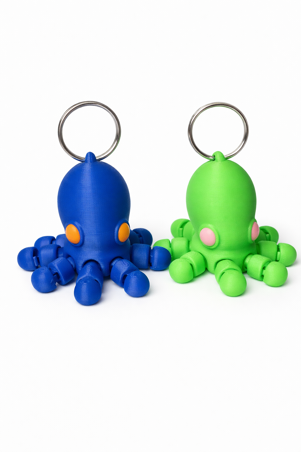 Blue and green 3D-printed baby octopus keychains with articulated tentacles and cute eye details